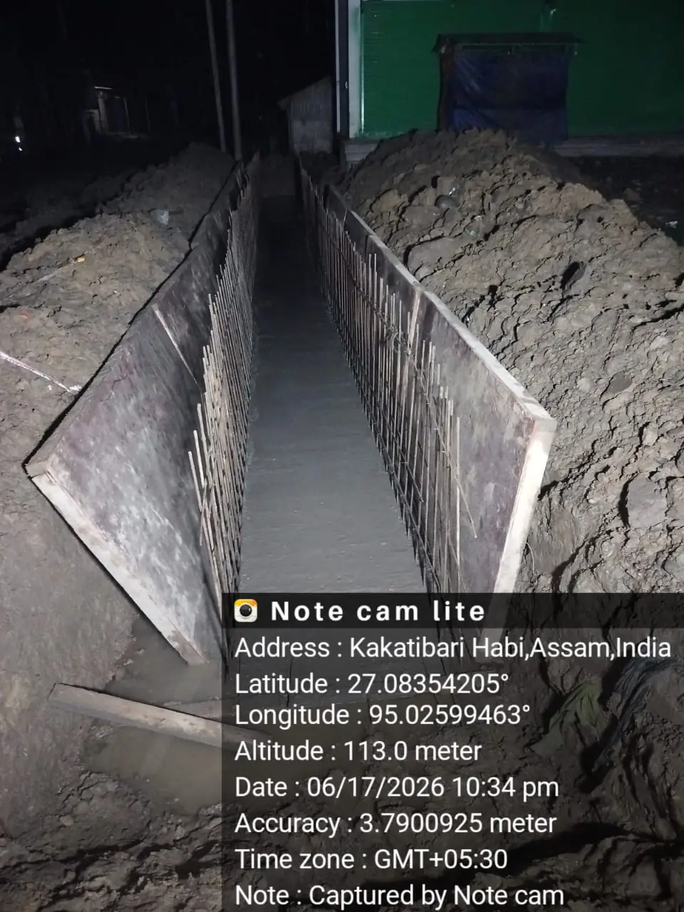 Freshly poured concrete culvert, night shift, Assam