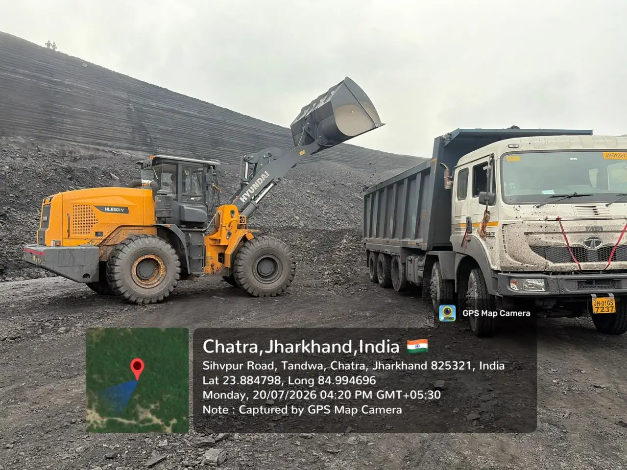 Wheel loader with raised bucket at coal stockpile, Chatra, Jharkhand